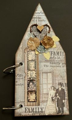 a house shaped photo frame with family pictures and flowers on the front, along with an image of a man and woman