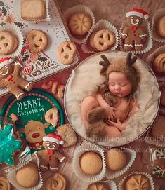 a baby is laying in a bowl surrounded by christmas cookies and other holiday decorations, with a teddy bear