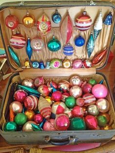 an open suitcase filled with assorted ornaments