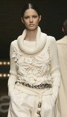 an instagram photo of a model on the catwalk wearing a white sweater and skirt