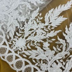 Introducing one of the most beautiful lace fabric pieces of couture you'll ever find - Beaded & Corded Bridal Fabric Lace Embroidered on 100% Polyester Net Mesh by Lace USA! Whether you are in search of a custom-made wedding dress, evening gown, dance costume, or special occasion apparel, this stunning lace fabric is the perfect choice. Gorgeous beaded and corded bridal lace fabric with exquisite embroidery on 100% polyester net mesh provides an exquisite shopping experience of couture, perfect Embellished Lace Dupatta For Wedding, Wedding Lace Dupatta Embellished, White Lace Sequin Fabric For Festive Occasions, Festive Lace Fabric With Pearl Embroidery, Festive Pearl Embroidered Lace Fabric, White Lace Embroidered Fabric For Festive Occasion, Festive White Lace Embroidered Fabric, Festive White Embroidered Lace, Quinceanera Crown