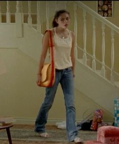 a woman standing in front of a stair case