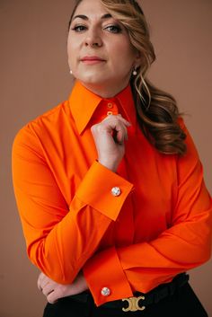 Welcome to DaDonnaBlouses Etsy store! Elevate your wardrobe with my exquisite collection of women's dress shirts, including my signature French Cuff Blouse. Meticulously crafted in my own factory, specializing in the art of shirtmaking. Indulge in sophistication with my  French cuff shirt for women, meticulously crafted from premium-grade cotton fabric with a touch of elastane. This high-quality blend ensures a comfortable fit and exceptional durability, making it a staple piece in your wardrobe for years to come. DaDonnaBlouses button-down shirt for women features a high collar and delicate details, exuding elegance and style. The vibrant, trend-forward color adds a pop of personality to any outfit, whether you're heading to the office or a formal event. Experience the perfect balance of Elegant Orange Blouse For Work, Elegant Fitted Orange Blouse, Fitted Elegant Orange Blouse, Fitted Blouse With Button Cuffs, Orange Long Sleeve Top For Formal Occasions, Classic Fitted Orange Shirt, Luxury Shirt With Buttons, Luxury Blouse With Button Cuffs And Spread Collar, Fitted Orange Shirt With Buttons