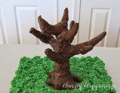 a cake that looks like a tree on top of green frosting and brown icing