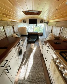 a kitchen area with washer, dryer and stove in an rv or camper