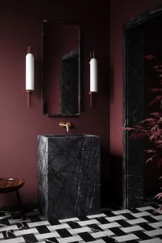 a black and white checkered floor in a bathroom with two mirrors on the wall