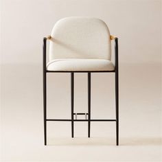 an upholstered bar stool with a black frame and white fabric seat, viewed from the front