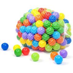 a bag full of colorful balls on a white surface with netted netting around it