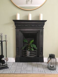 a living room with a fire place and candles