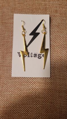 Gold Tone Lightning Bolt  Material is Brass These earrings sparkle beautifully! MEASUREMENTS: 2 INCHES LONG Edgy Gold Jewelry For Party, Edgy Gold Metal Earrings, Gold Edgy Dangle Jewelry, Edgy Gold Dangle Jewelry, Edgy Gold Earrings For Party, Sparkle Earrings, Lightning Bolt, Rock And Roll, Jewelry Earrings Dangle