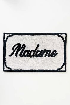 a black and white door mat with the word madison on it in cursive writing