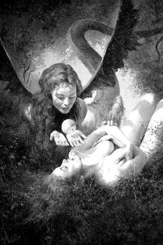 a woman laying on the ground next to an angel