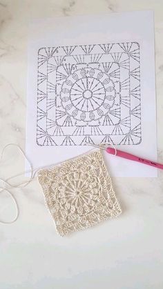 a crochet doily pattern next to a pair of scissors