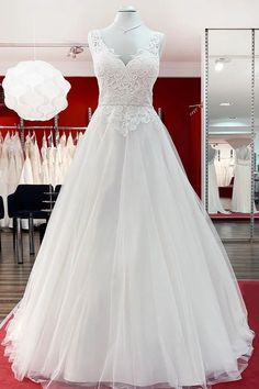 a white wedding dress on display in a store