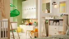 a baby's room is decorated in green and white