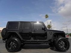 a black jeep parked in a parking lot