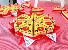 several pieces of pizza sitting on top of a red and white checkered table cloth