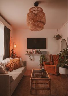 a living room filled with furniture and a flat screen tv mounted to the side of a wall