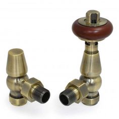 two brass faucets with wooden knobs on each side and one in the middle