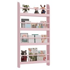 a pink book shelf filled with books on top of it's sides and two small figurines