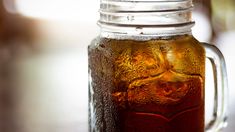 a mason jar filled with liquid sitting on top of a table