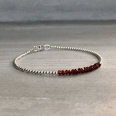 This gemstone bracelet features small genuine Garnet stones. The faceted garnet beads are a beautiful vibrant red hue. This piece is timeless, yet unique. A perfect gift for a birthday or for your Valentine. The tiny round beads frame the faceted gemstones beautifully. At checkout, choose to buy a Garnet bracelet with gold or sterling silver beads. * METAPHYSICAL PROPERTIES OF GARNETS * courage energy love passion self confidence transformation Free gift with every crystal jewelry purchase from Dainty Faceted Beaded Bracelets, Faceted Rondelle Crystal Bracelet Gift, Minimalist Faceted Rondelle Beaded Bracelets, Minimalist Crystal Bracelet With Faceted Beads, Faceted Rondelle Beaded Bracelets As Gift, Faceted Rondelle Beaded Bracelets, Minimalist Bracelets With Faceted Rondelle Beads, Minimalist Faceted Beads Rondelle Bracelets, Minimalist Rondelle Bracelets With Faceted Beads