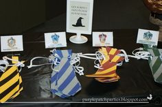 several harry potter themed items are on display at the table with tags attached to them