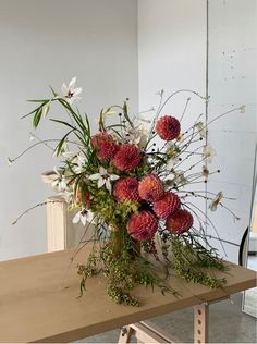 a bouquet of flowers sitting on top of a wooden table