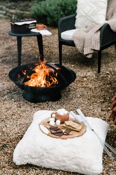 a fire pit sitting on top of a gravel field