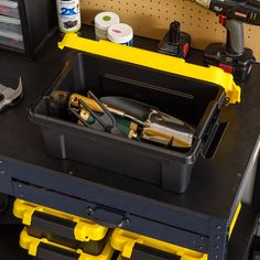 a toolbox with tools in it sitting on a workbench