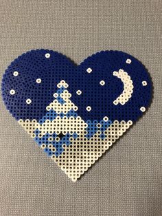 a blue and white heart made out of perler beads