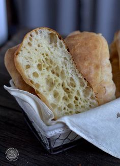 two loaves of bread in a basket on a table