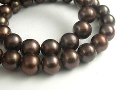 two strands of brown pearls on a white background