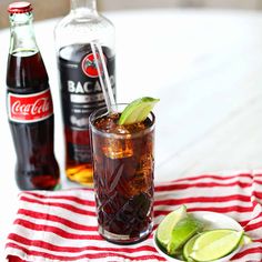 an alcoholic drink with limes and coke