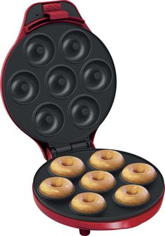 an electric donut maker with six donuts in it's trays on a white background