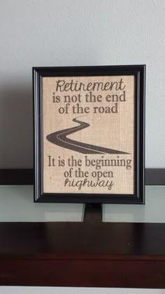 a framed sign that says retirement is not the end of the road it is the beginning of the open highway