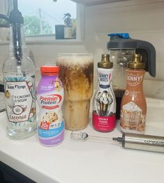 there are many different types of drinks on the counter top, including iced coffee and ice cream