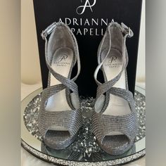 Elevate Your Style With These Stunning Adrianna Papell Rosalie High Heel Shoes. Crafted With Premium Quality Silver Leather, These Strappy Heels Feature A Metal-Themed Design That Adds A Touch Of Glamour To Any Outfit. The Shoes Are Brand New And Come In Their Original Box, Ready To Be Shipped To Your Doorstep. With A Us Shoe Size Of 9, These Heels Are Perfect For Women Who Want To Make A Bold Fashion Statement. The Pewter Color Complements Any Clothing Style And The Sturdy Construction Ensures Elegant Metallic Synthetic Heels, Silver Almond Toe Sandals With 4-inch Heel, Silver Almond Toe Heels In Synthetic, Silver Almond Toe Synthetic Heels, Silver Synthetic Heels For Gala, Formal Silver Sandals With Almond Toe, Silver Almond Toe Sandals For Formal Occasions, Pewter Color, Color Complement