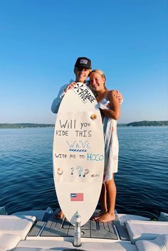 two people standing on a boat holding a surfboard that says will you ride this wave with me to haco?