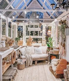 a living room filled with furniture and lots of windows covered in glass roof coverings