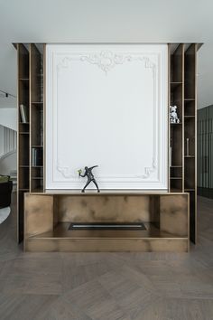 a living room with a book shelf and a white board on the wall