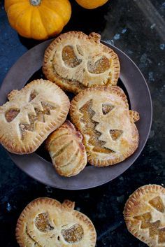 pumpkin pies with jack - o'- lanterns carved into them on a plate