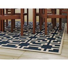 a blue and white rug with chairs around it