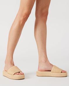 The BEACHY square toe sandal secured a woven raffia wrapped flatform sole with a matching wide slide strap for a super comfy textured look. Square toe flatform slide sandal Slip-on style Woven raffia wrapped sole 1.5 inch heel height Raffia upper material Textile lining Vegan leather sock Synthetic sole Imported Comfortable Beach Platform Slippers With Textured Sole, Comfortable Platform Slippers With Textured Sole For Beach, Beige Cushioned Platform Slippers For Beach, Summer Platform Footbed Sandals For Vacation, Comfortable Summer Platform Slippers With Textured Sole, Summer Beach Footbed Platform Sandals, Summer Platform Footbed Sandals For Beach, Comfortable Spring Platform Slippers With Textured Sole, Summer Open Toe Footbed Sandals With Textured Sole