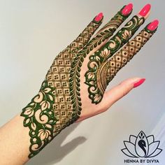 a woman's hand with henna tattoos on her arm and hands, showing the intricate