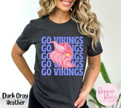 This bright Vikings shirt is perfect for Viking fans, teachers, and students!  The colors make it unique, and the style is perfect for game day or any day!  * Bella Canvas 3001 * Unisex Adult Sizing * Listing is for shirt ONLY, props and other articles of clothing are not included BELLA CANVAS CREWNECK TEE * This classic unisex jersey short sleeve tee fits like a well-loved favorite. Soft cotton and quality print make users fall in love with it over and over again. These t-shirts have-ribbed knit collars to bolster shaping. The shoulders have taping for better fit over time. Dual side seams hold the garment's shape for longer.  -Solid colors are 100% cotton, heather colors are 52% cotton, 48% polyester, (Athletic Heather and Black Heather are 90% cotton, 10% polyester.  -Runs true to size Casual Pink Tops With Team Logo, Pink Team Spirit T-shirt For Fans, Pink Tops Team Spirit Fan Gear, Pink Team Spirit Tops For Fan Gear, Pink Tops For Fan Gear With Team Spirit, Pink Team Spirit T-shirt With Team Name, Team Spirit Pink T-shirt With Team Name, Collegiate Pink Tops With Graphic Print, Pink Tops With Team Name For Fan Gear