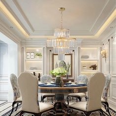 an elegant dining room with chandelier, chairs and table surrounded by white walls