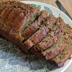 sliced loaf of banana bread sitting on top of a white plate