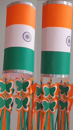 two orange and green paper lamps with shamrocks on them, hanging from the ceiling