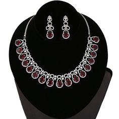 American Diamond bridal collar choker necklace studded with emerald green, ruby red and clear CZ stones encrusted on silver tone rhodium background. Necklace comes with a pair of matching earrings. This is very unique and beautiful Indian Necklace set studded high quality AD stones beautifully decorated work. Stone shape: emerald cut and Pear Necklace Length: 9 inches+ Length of Extender is 9 inches Earring Length: 1.9 inches Contents: 1 Necklace, 2 Earrings Best suitable for Party Wear / Fashio Elegant Red Rhinestone Necklaces, Elegant Red Rhinestone Necklace For Formal Occasions, Elegant Red Rhinestone Necklace For Formal Events, Elegant Red Rhinestone Necklace, Elegant Red Choker Jewelry Sets, Red Crystal Jewelry With Rhinestones, Red Crystal Rhinestone Jewelry, Elegant Jeweled Red Bridal Necklace, Red Choker Bridal Necklace For Party